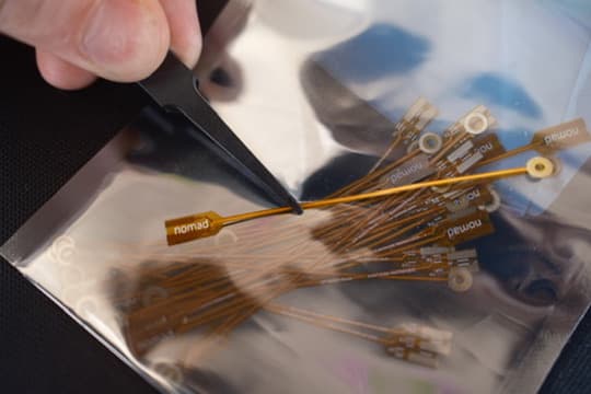 nomad-branded flexible electrodes, handled with tweezers